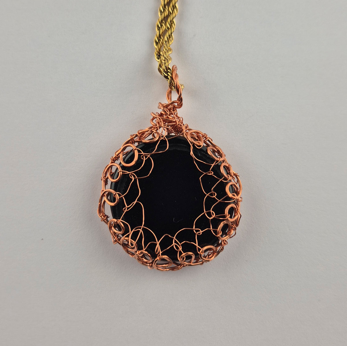 Copper wire wrapped round dichroic glass pendant